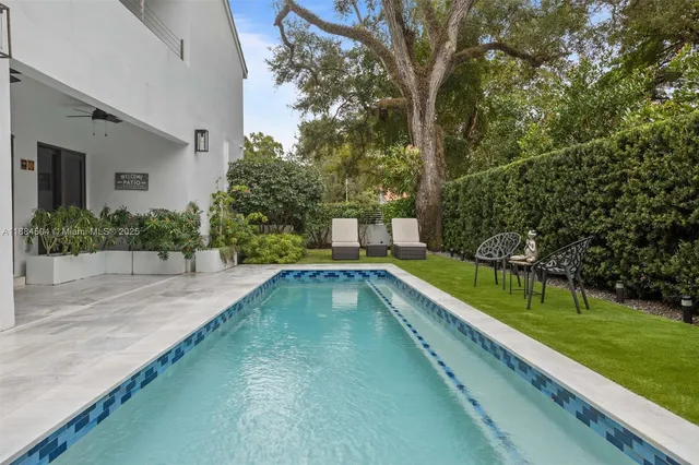 a view of a house with sitting area and potted plants