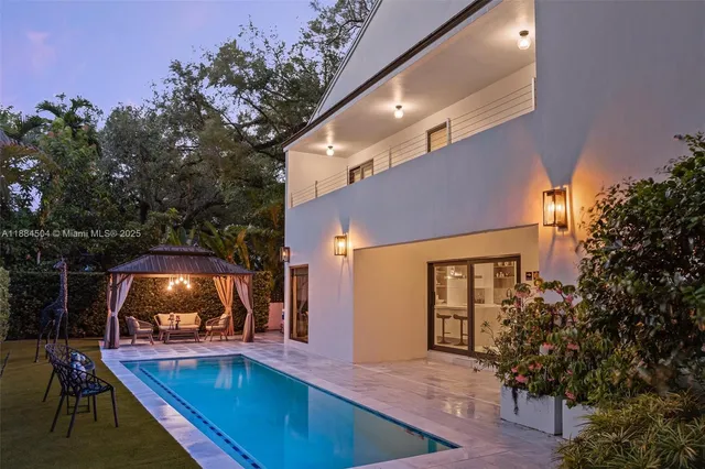 swimming pool view with a seating space