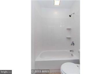 2978 Cornwall Road Dundalk, MD 21222 - Photo 12 of 27 a bathroom with a shower curtain and a sink