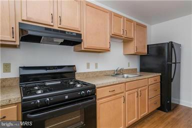 2978 Cornwall Road Dundalk, MD 21222 - Photo 24 of 27 a kitchen with stainless steel appliances granite countertop a stove and a refrigerator
