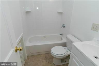 2978 Cornwall Road Dundalk, MD 21222 - Photo 25 of 27 a bathroom with a toilet and bathtub