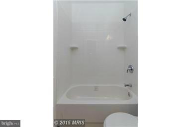 2978 Cornwall Road Dundalk, MD 21222 - Photo 26 of 27 a bathroom with a tub shower sink and a toilet
