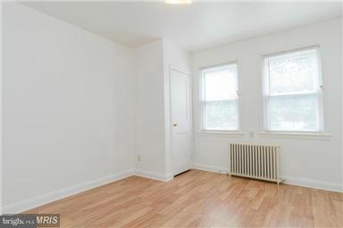 2978 Cornwall Road Dundalk, MD 21222 - Photo 5 of 27 an empty room with wooden floor and windows