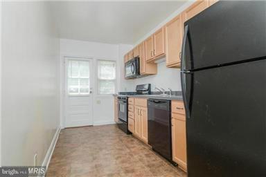 2978 Cornwall Road Dundalk, MD 21222 - Photo 8 of 27 a kitchen with a refrigerator and a stove
