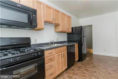 2978 Cornwall Road Dundalk, MD 21222 - Photo 9 of 27 a kitchen with stainless steel appliances a stove a microwave and refrigerator