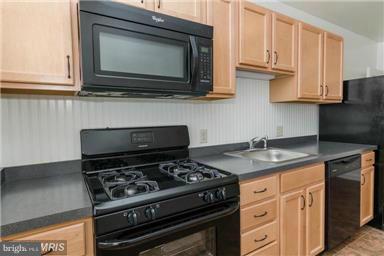 2978 Cornwall Road Dundalk, MD 21222 - Photo 10 of 27 a kitchen with stainless steel appliances granite countertop white cabinets and a stove top oven
