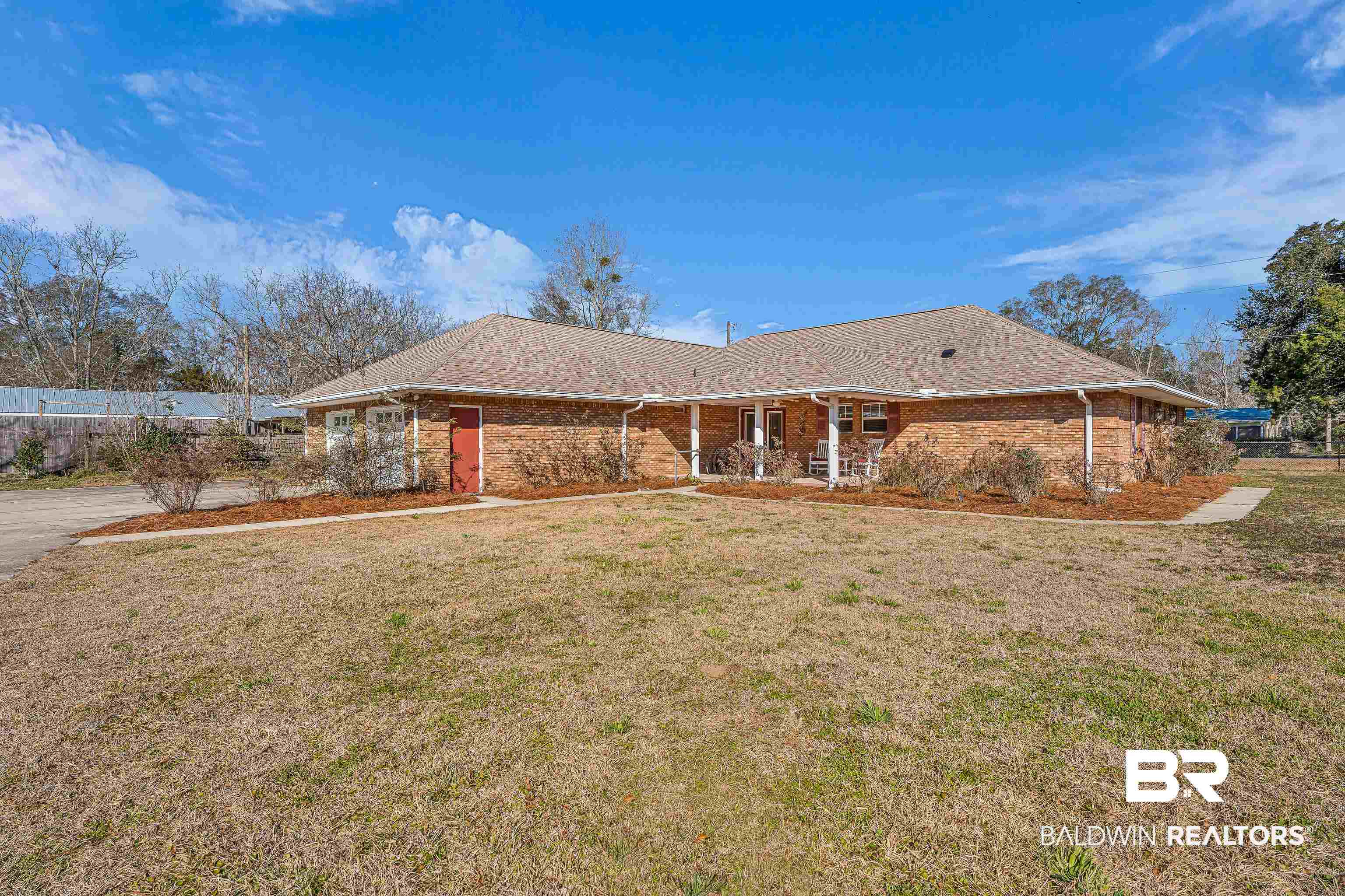22095 8th Street Silverhill, AL 36576 - Photo 7 of 42 View of front facade featuring brick siding, covered porch, and a shingled roof