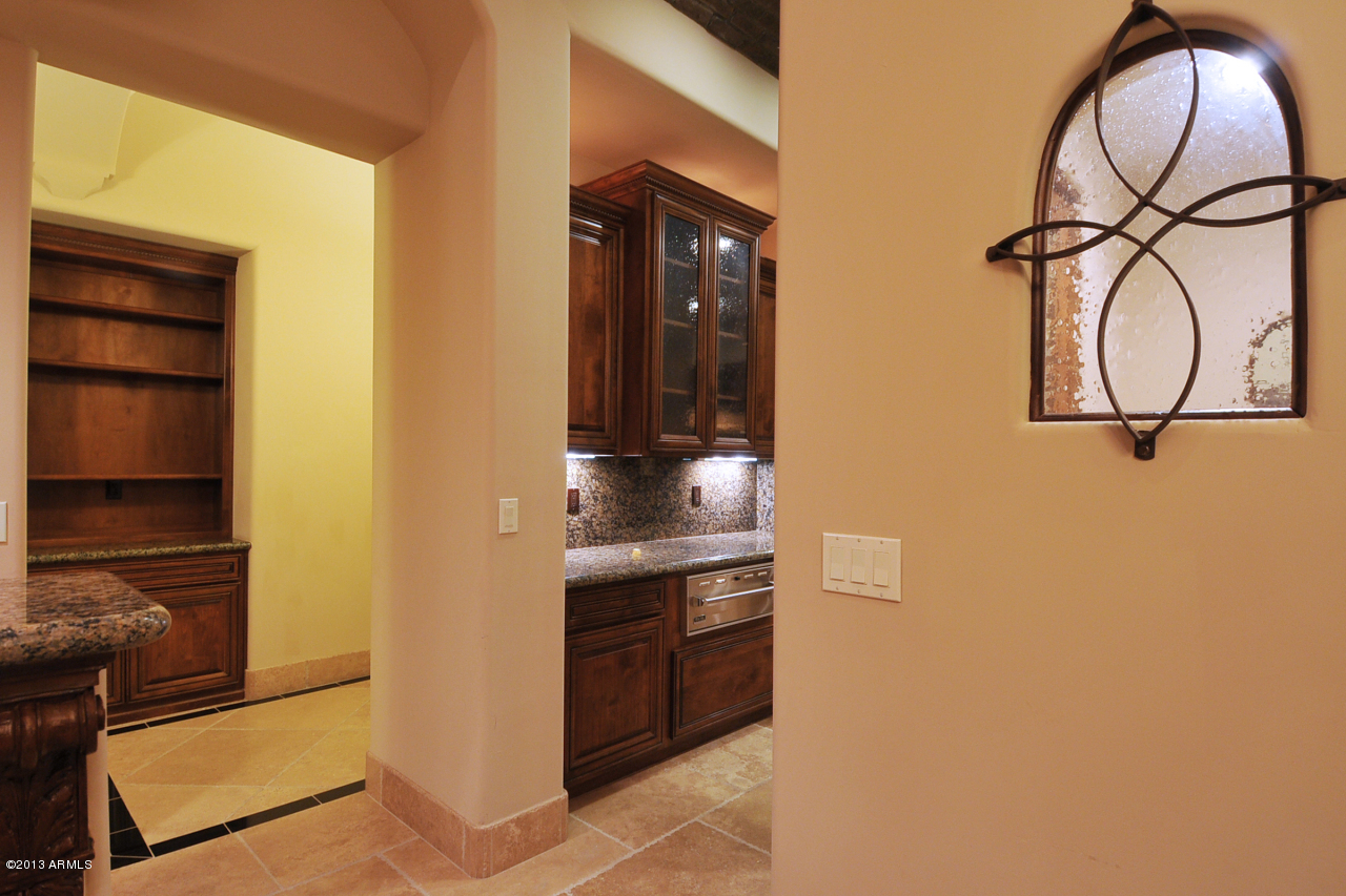 12827 East Cibola Road Scottsdale, AZ 85259 - Photo 12 of 64 a kitchen with stainless steel appliances granite countertop a stove and a microwave