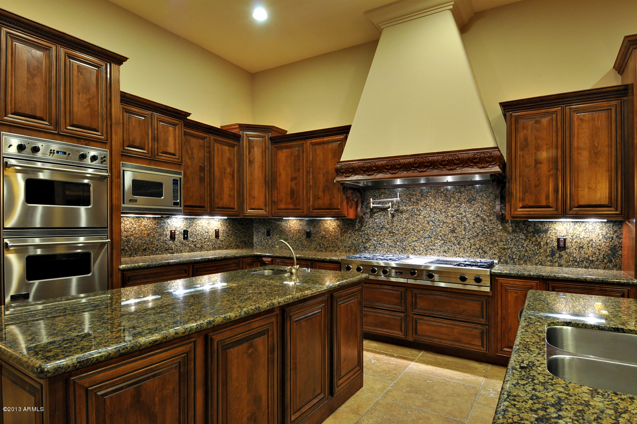 12827 East Cibola Road Scottsdale, AZ 85259 - Photo 15 of 64 a kitchen with stainless steel appliances granite countertop a stove a sink and a microwave