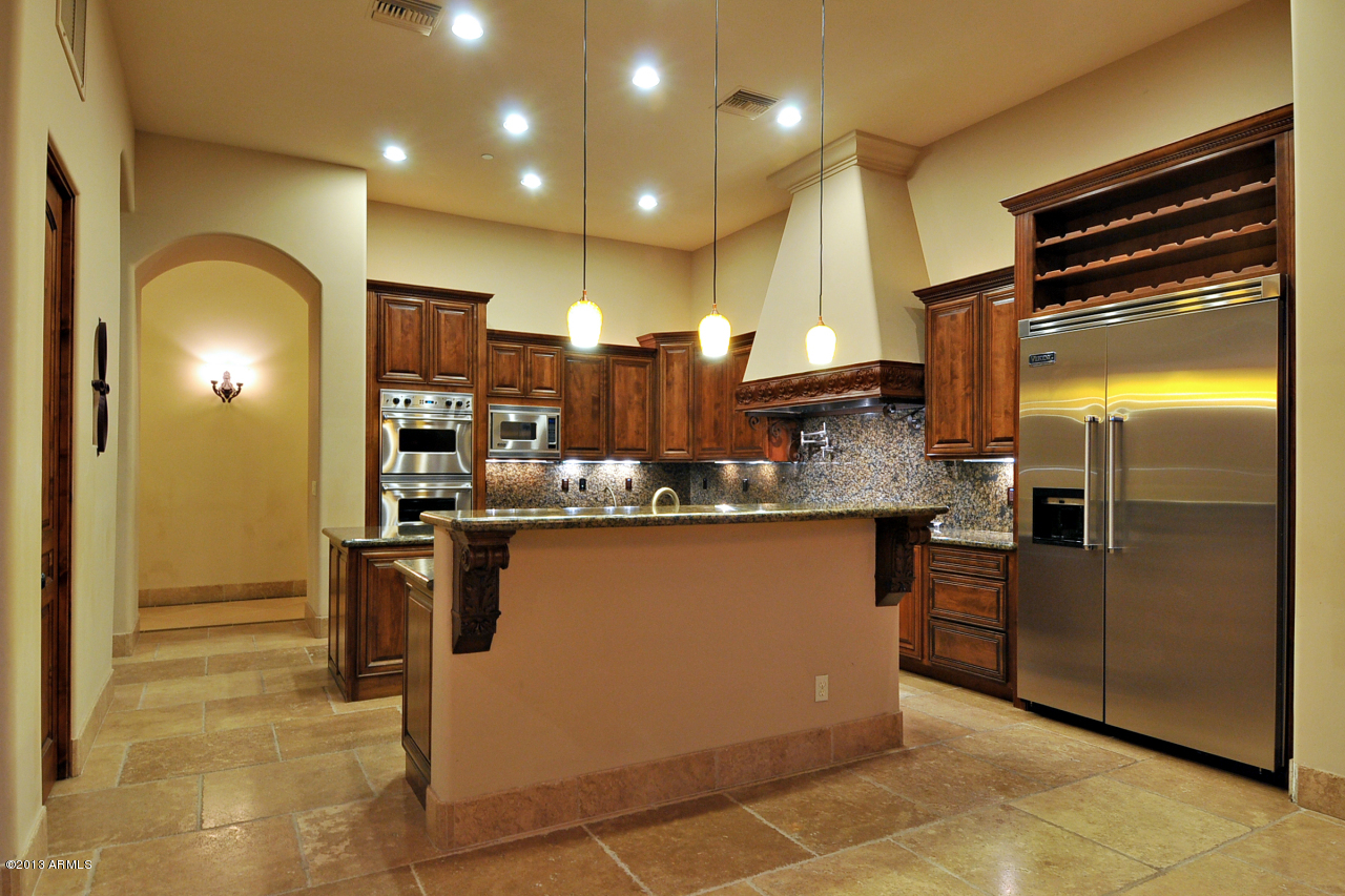 12827 East Cibola Road Scottsdale, AZ 85259 - Photo 17 of 64 a kitchen with stainless steel appliances granite countertop a refrigerator and a stove