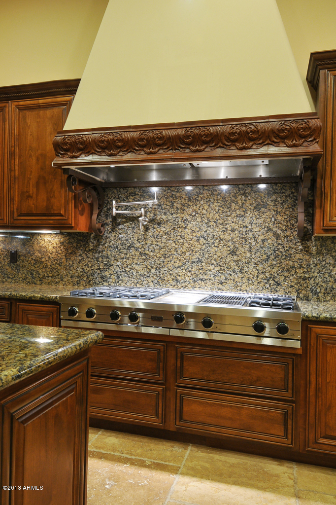 12827 East Cibola Road Scottsdale, AZ 85259 - Photo 18 of 64 a stove top oven sitting inside of a kitchen