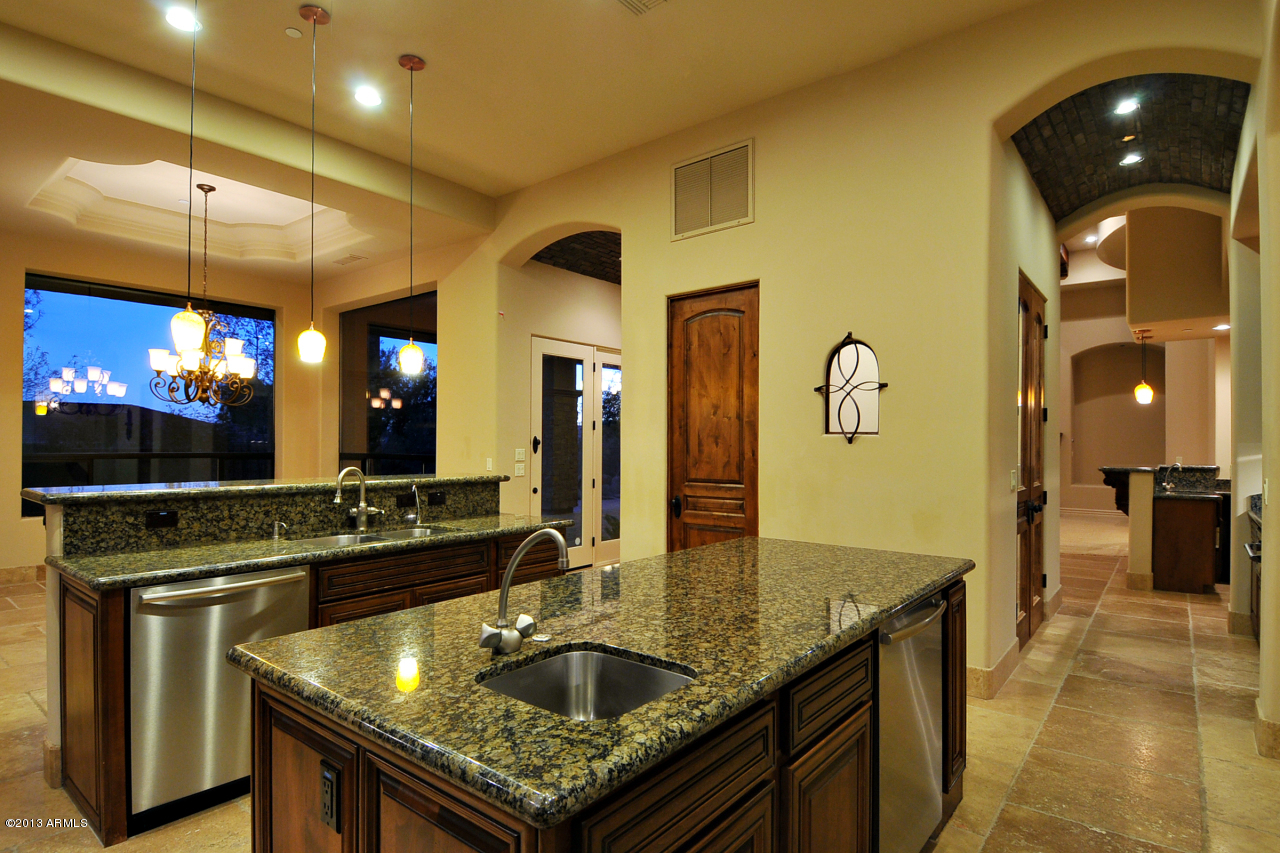 12827 East Cibola Road Scottsdale, AZ 85259 - Photo 19 of 64 a kitchen with stainless steel appliances granite countertop a sink and counter space