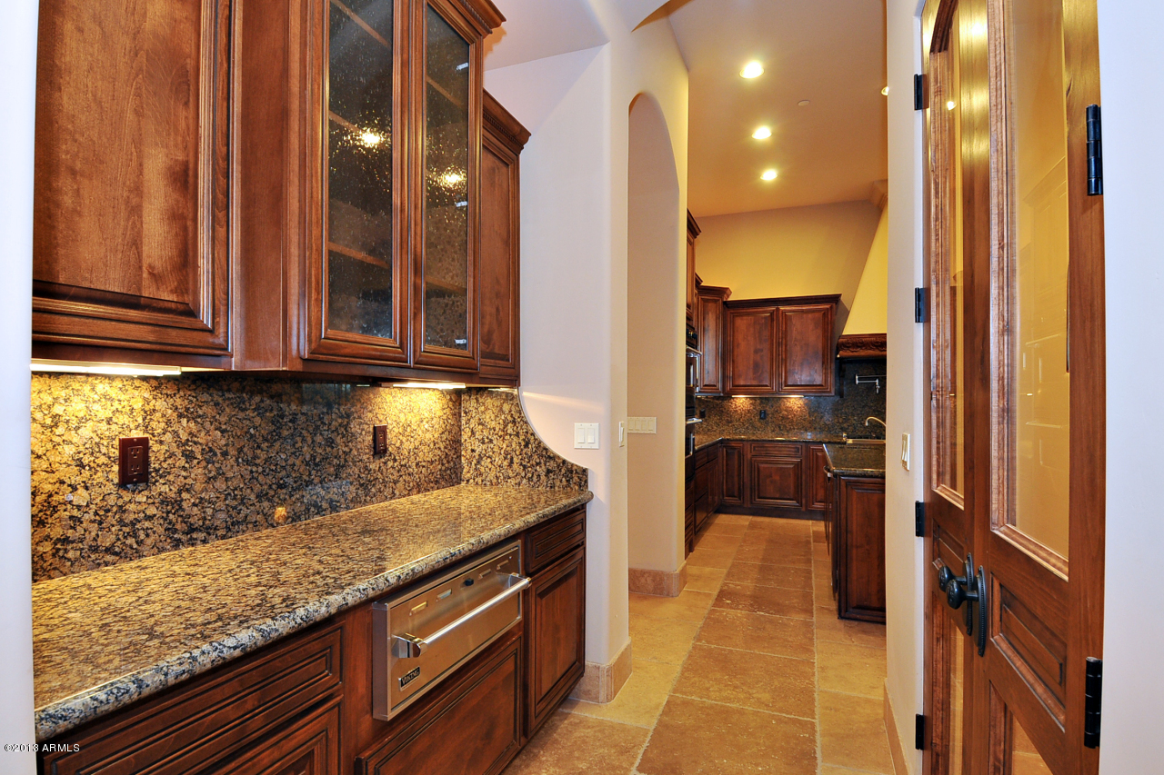12827 East Cibola Road Scottsdale, AZ 85259 - Photo 20 of 64 a kitchen with stainless steel appliances granite countertop wooden cabinets and granite counter tops