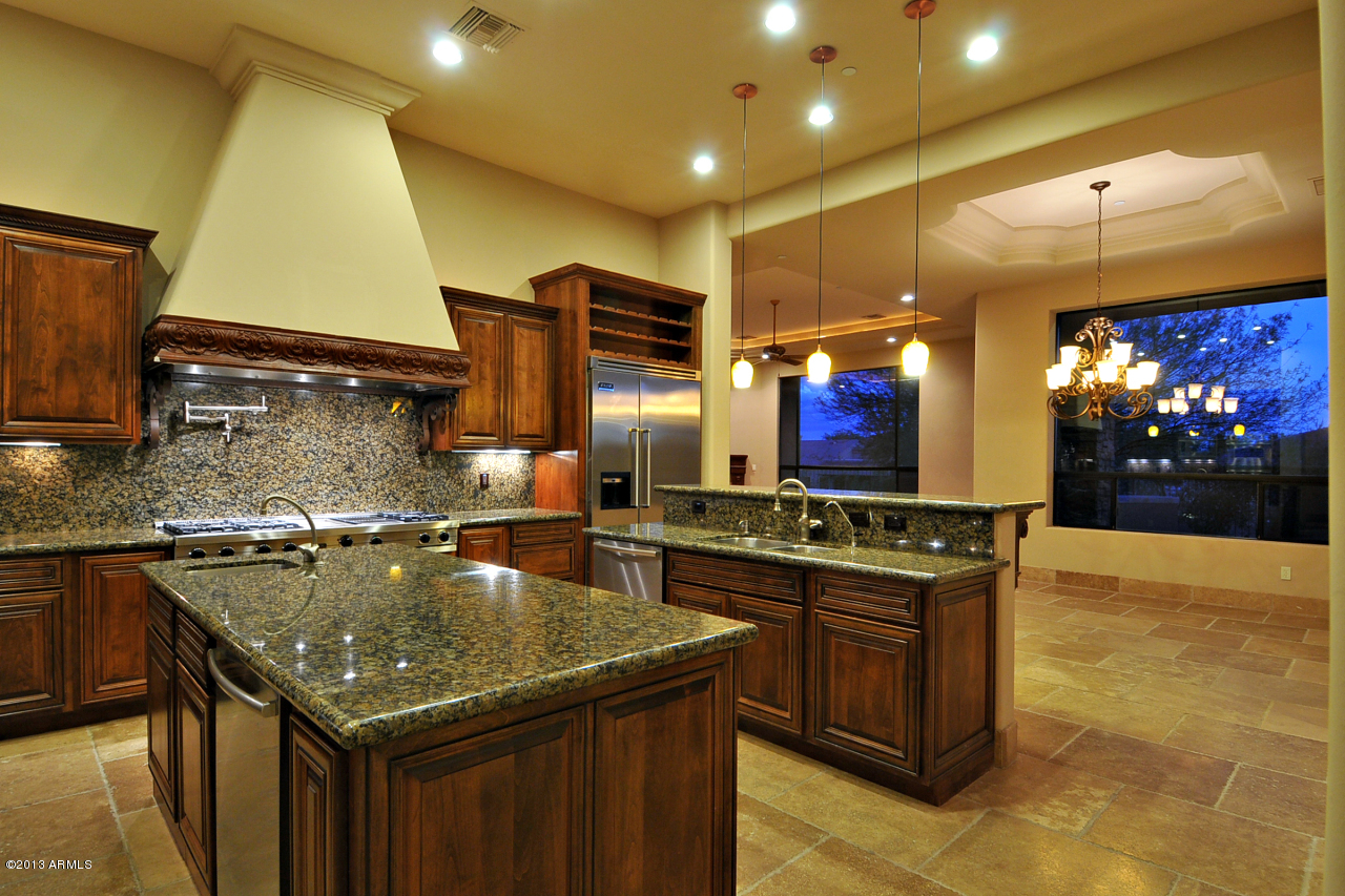 12827 East Cibola Road Scottsdale, AZ 85259 - Photo 3 of 64 a kitchen with stainless steel appliances granite countertop a sink and a stove
