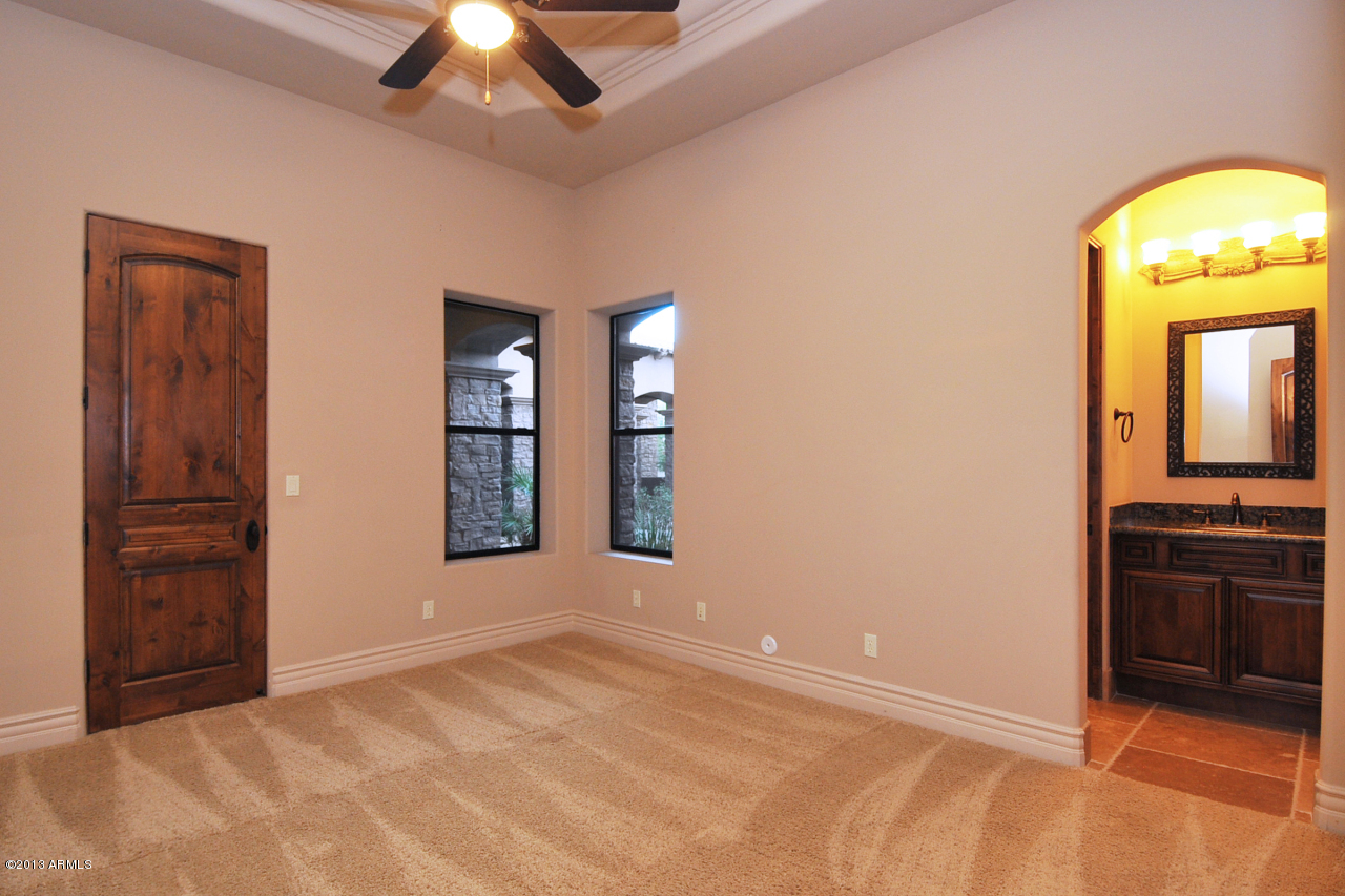 12827 East Cibola Road Scottsdale, AZ 85259 - Photo 35 of 64 an empty room with closet and a chandelier fan