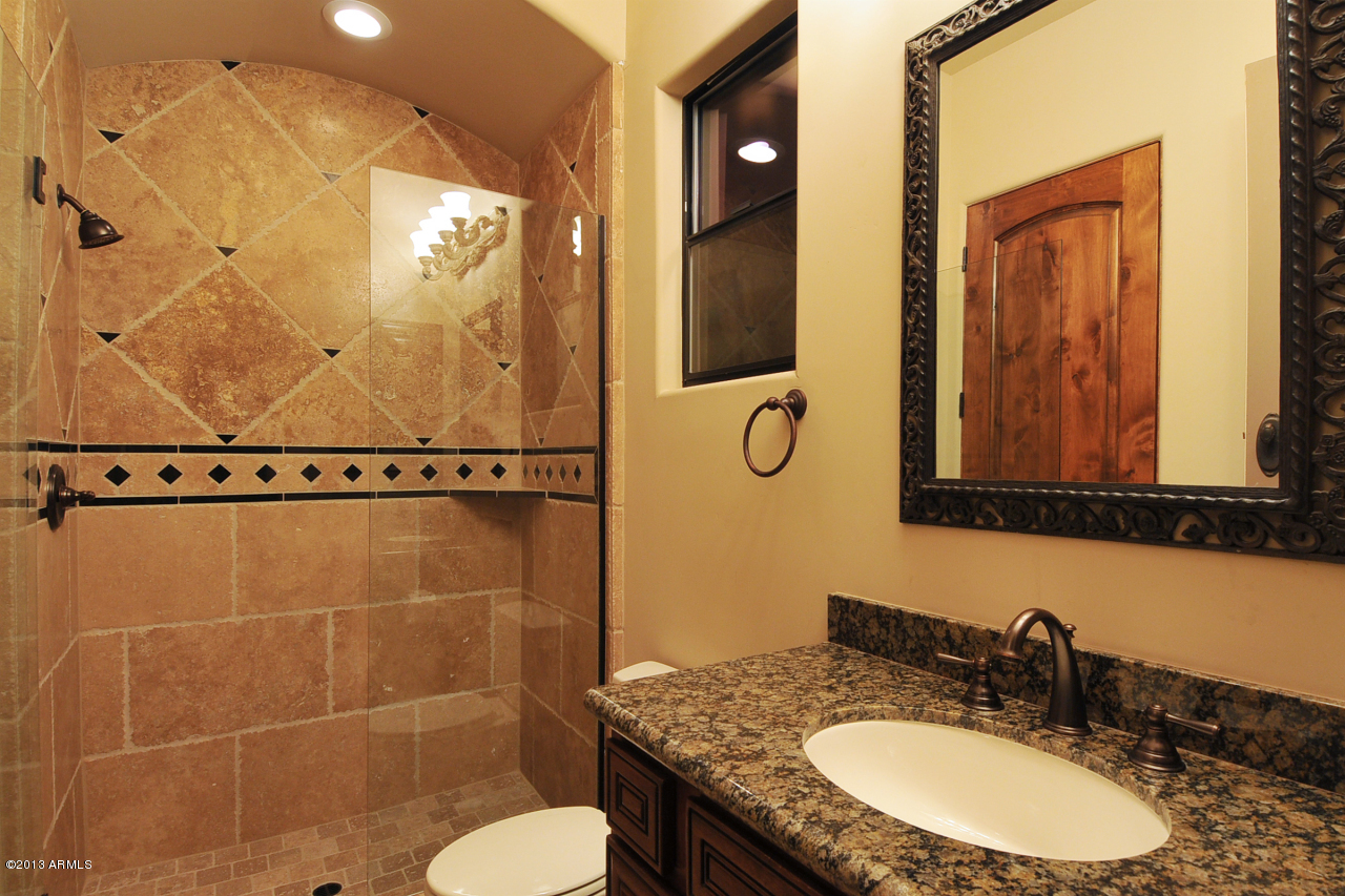 12827 East Cibola Road Scottsdale, AZ 85259 - Photo 36 of 64 a bathroom with a granite countertop sink and a mirror