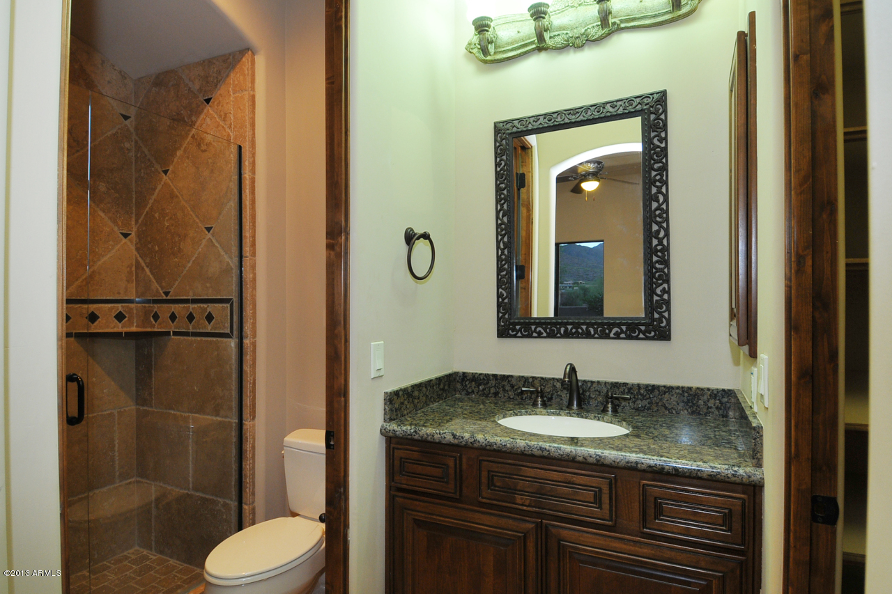 12827 East Cibola Road Scottsdale, AZ 85259 - Photo 39 of 64 a bathroom with a granite countertop sink toilet and shower