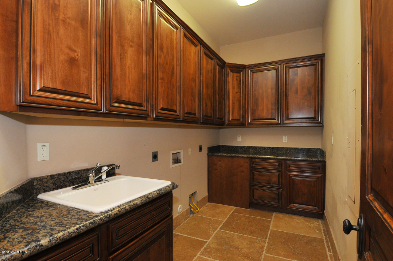 12827 East Cibola Road Scottsdale, AZ 85259 - Photo 46 of 64 a kitchen with granite countertop a sink stove and cabinets