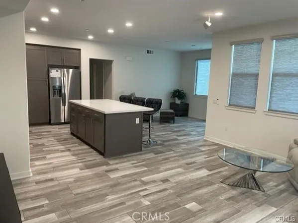 a living room with granite countertop furniture and a wooden floor