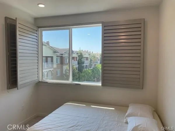 a view of a room that has a window and wooden floor