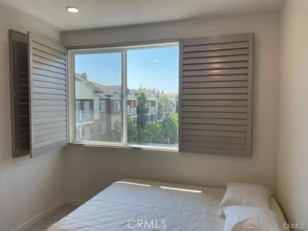 a view of a room that has a bed and a window