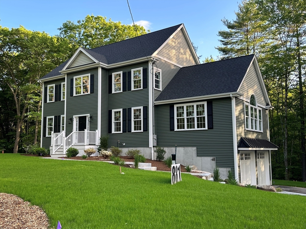881 Maple Street Mansfield, MA 02048 - Photo 1 of 34 a front view of a house with a yard