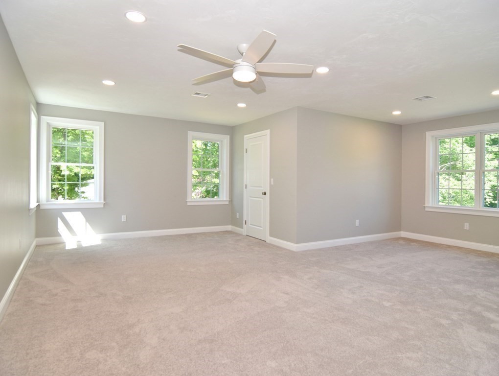 881 Maple Street Mansfield, MA 02048 - Photo 19 of 34 an empty room with windows and ceiling fan