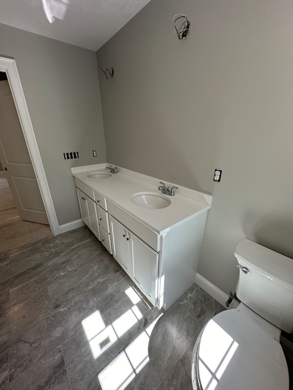 881 Maple Street Mansfield, MA 02048 - Photo 27 of 34 a bathroom with a granite countertop sink and a toilet