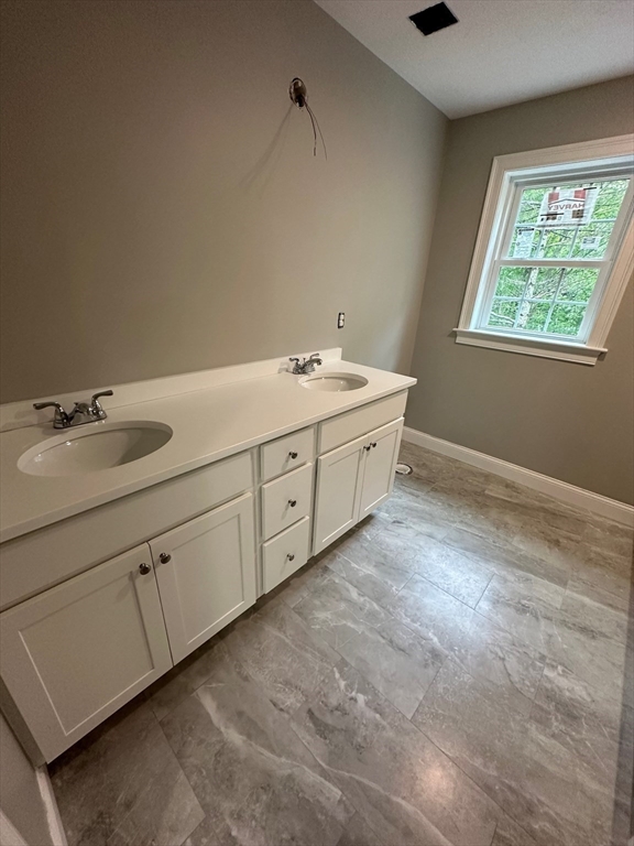 881 Maple Street Mansfield, MA 02048 - Photo 28 of 34 a bathroom with a granite countertop sink and a window