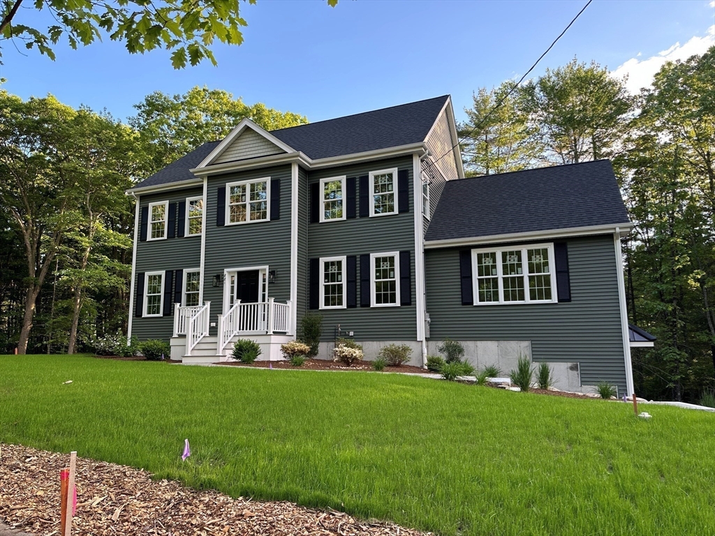 881 Maple Street Mansfield, MA 02048 - Photo 3 of 34 a front view of a house with a yard and trees