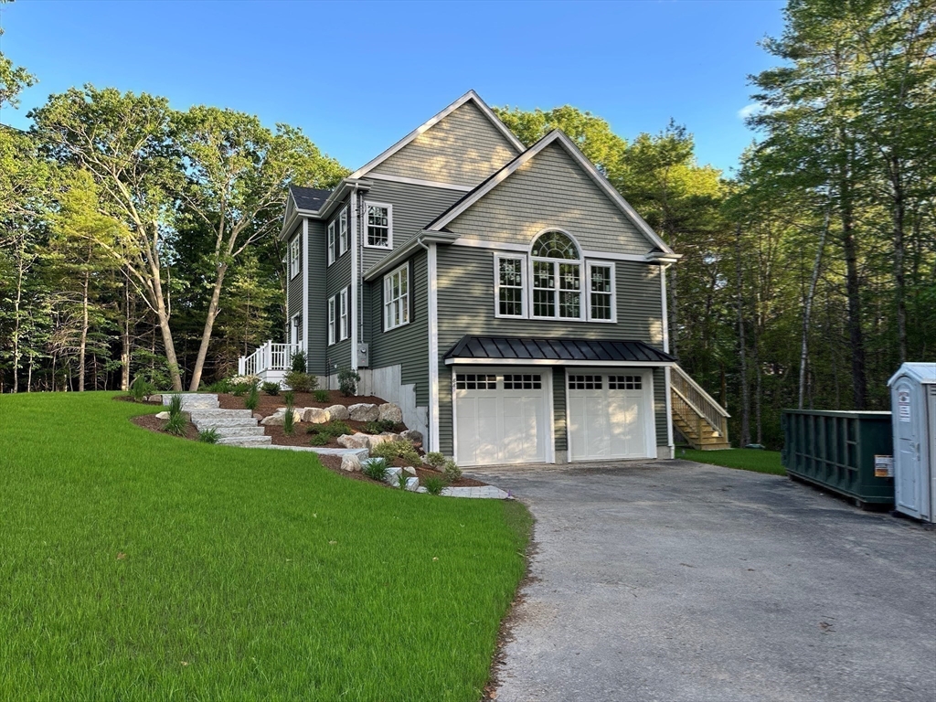 881 Maple Street Mansfield, MA 02048 - Photo 31 of 34 a front view of a house with a yard and trees
