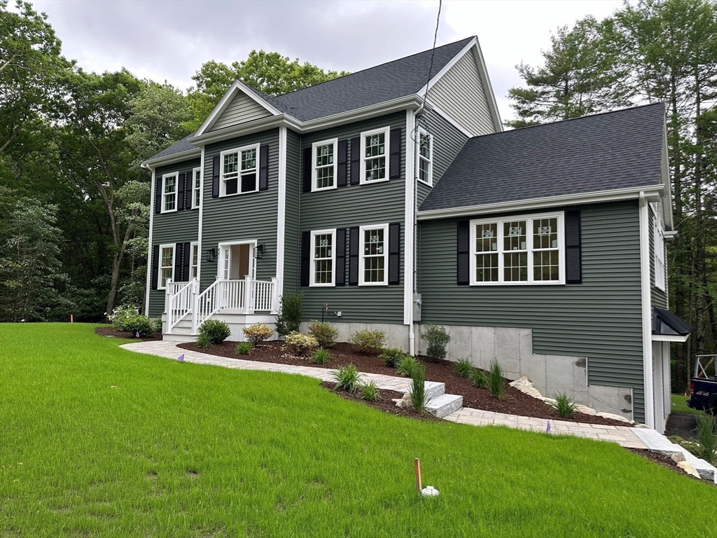 881 Maple Street Mansfield, MA 02048 - Photo 34 of 34 a front view of a house with a yard and trees