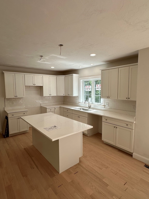 881 Maple Street Mansfield, MA 02048 - Photo 5 of 34 a kitchen with a sink stove and cabinets