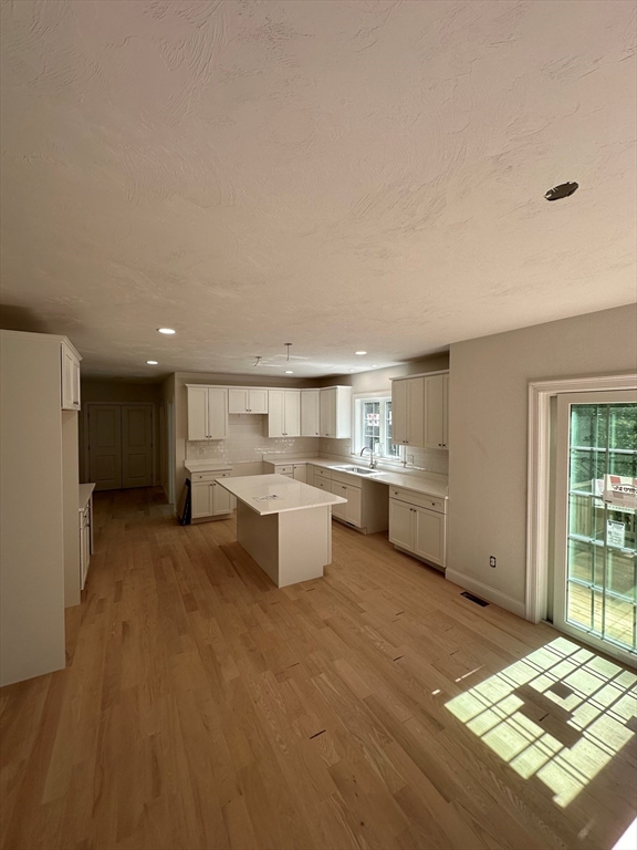 881 Maple Street Mansfield, MA 02048 - Photo 6 of 34 a open kitchen with white cabinets and white appliances