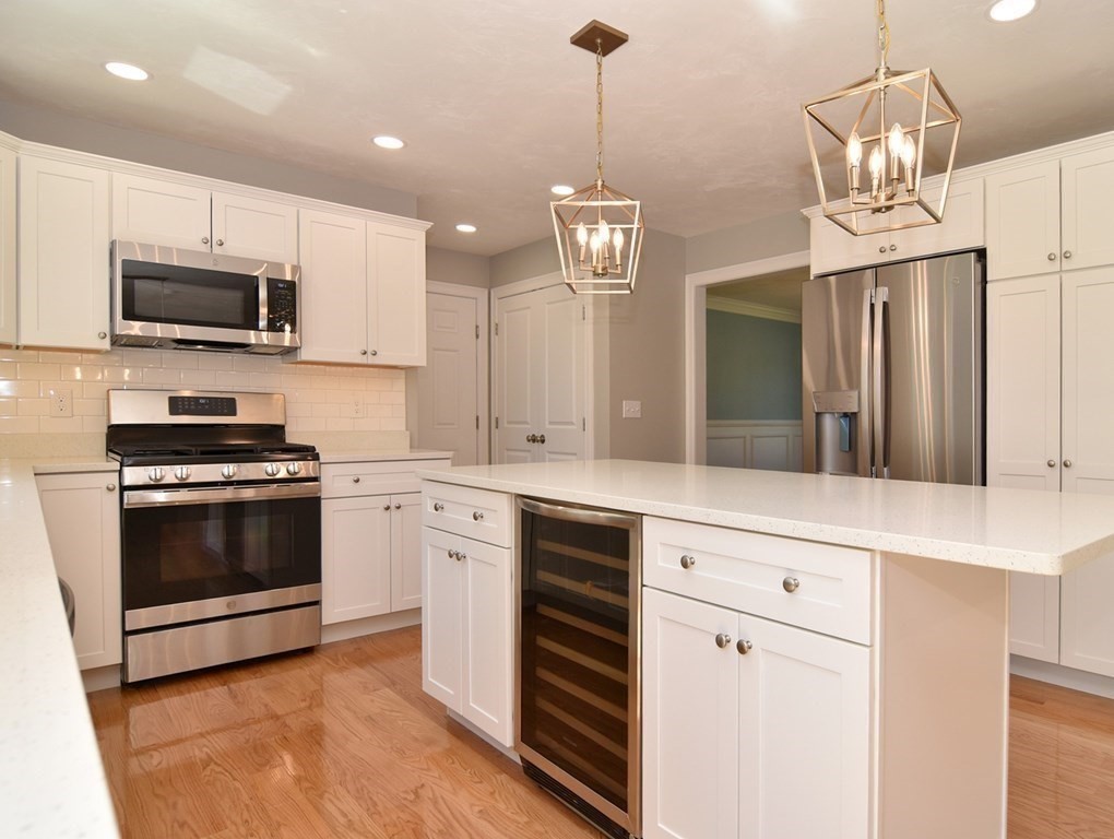 881 Maple Street Mansfield, MA 02048 - Photo 7 of 34 a kitchen with stainless steel appliances a stove top oven a sink and dishwasher