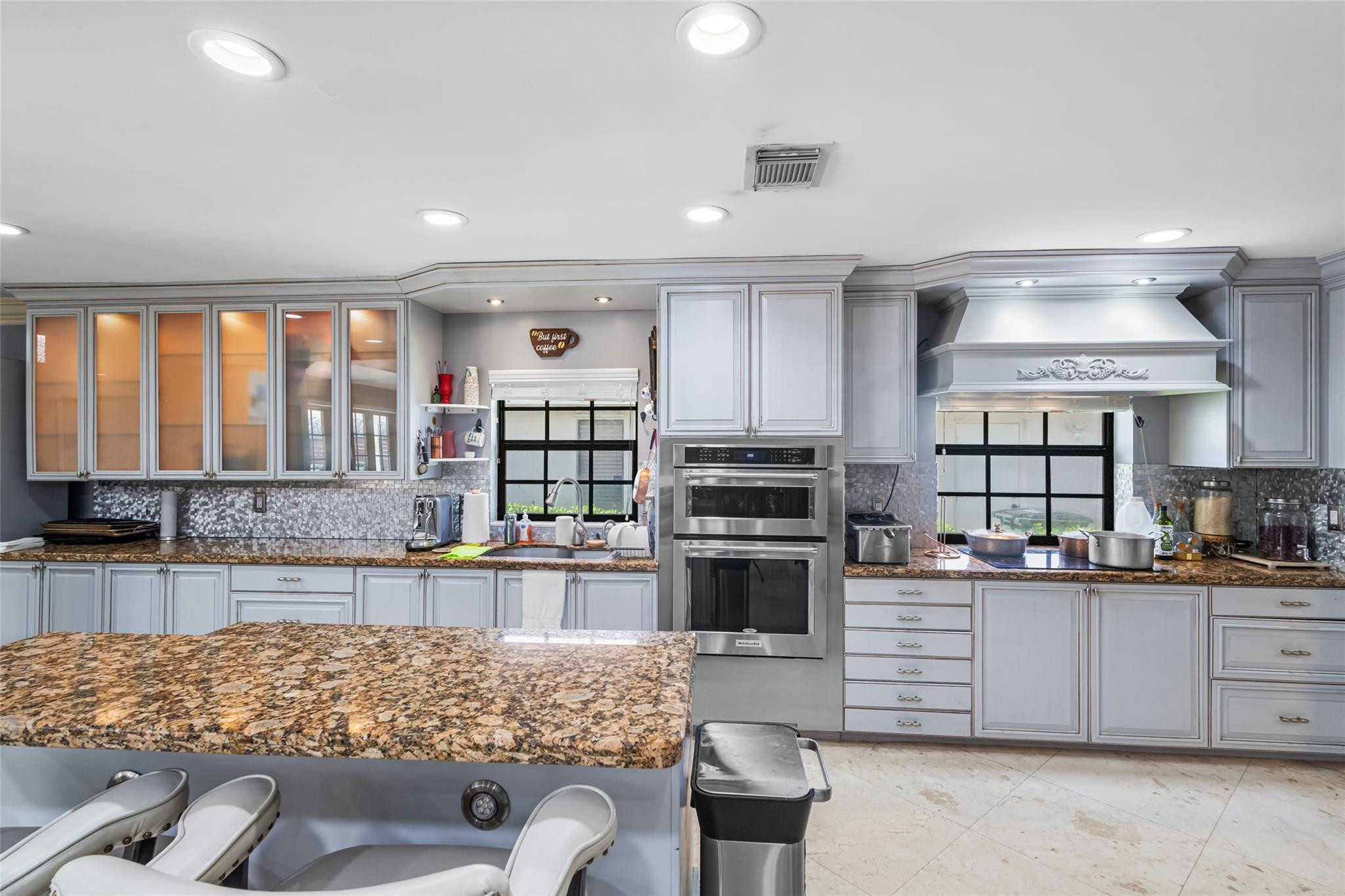 5223 Deerhurst Crescent Circle Boca Raton, FL 33486 - Photo 22 of 51 a kitchen with stainless steel appliances kitchen island granite countertop a stove and cabinets