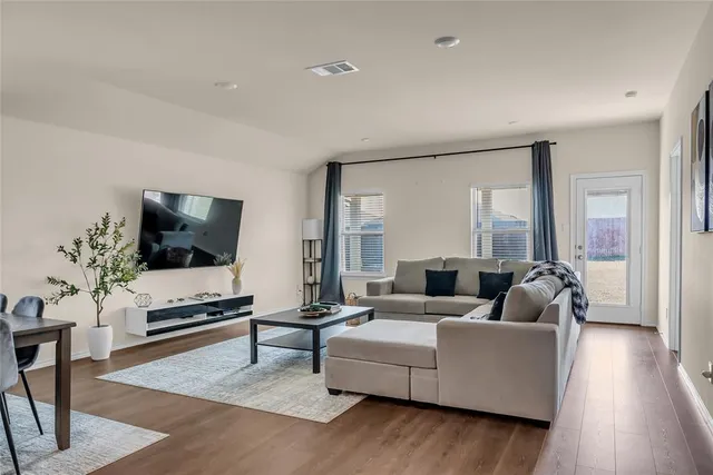 a living room with furniture rug and wooden floor