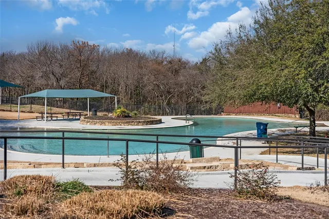 a view of a park with iron fence