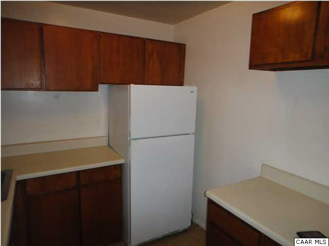 511 1st Street North, Unit 203 Charlottesville, VA 22902 - Photo 3 of 9 a white refrigerator freezer sitting inside of a kitchen