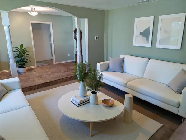 a view of a dining room with furniture a rug and wooden floor
