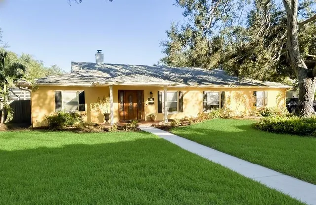 a view of a house with backyard porch and sitting area