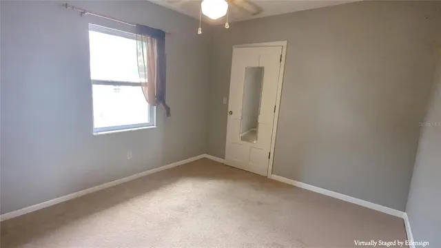 a spacious bedroom with a bed and a painting on the wall