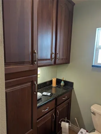 a bathroom with a double vanity sink mirror and toilet