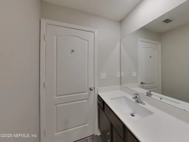 a bathroom with a sink and mirror