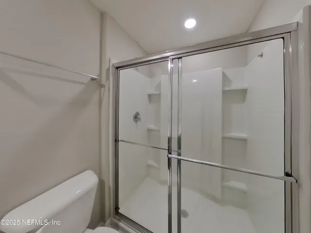 a bathroom with a glass shower door