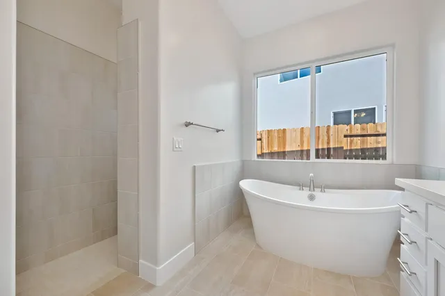 a white bath tub sitting next to a white sink