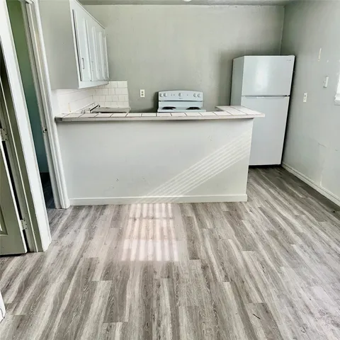 a view of a room with wooden floor