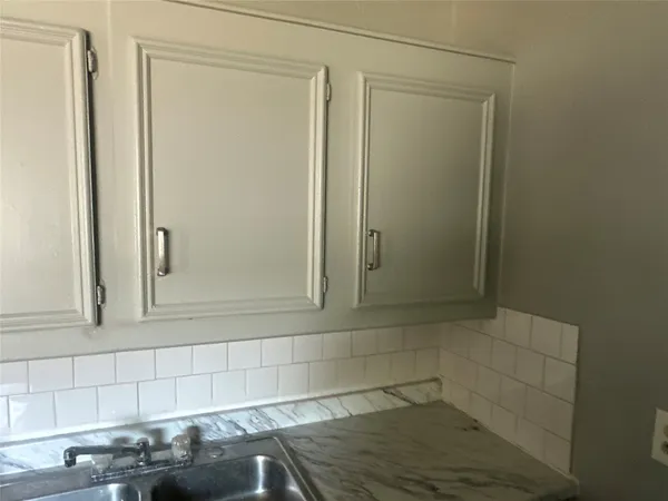 a bathroom with a shower and a sink