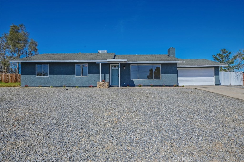 15650 Jaypost Road Victorville, CA 92394 - Photo 1 of 1 a front view of a house with a yard and potted plants