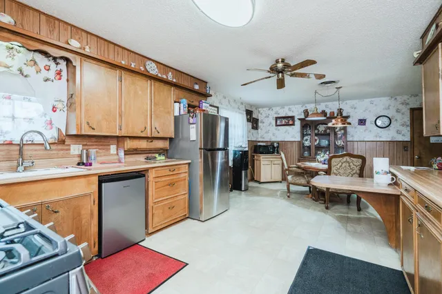 a kitchen with a refrigerator and a sink
